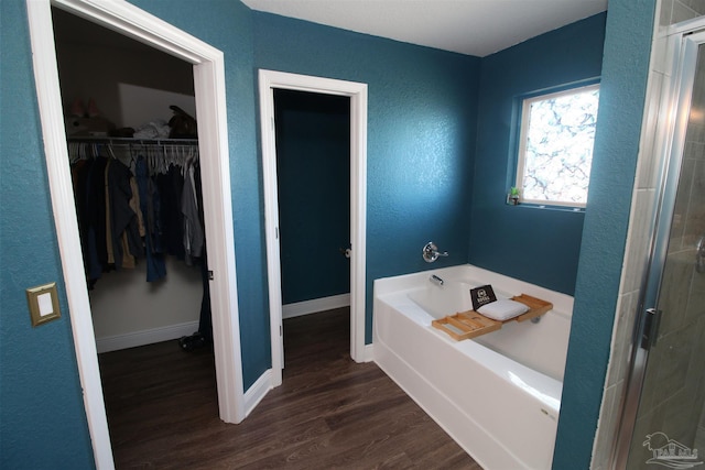 bathroom featuring a bath and hardwood / wood-style flooring