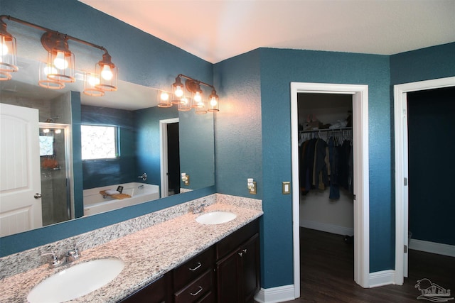 bathroom featuring wood-type flooring, vanity, and independent shower and bath