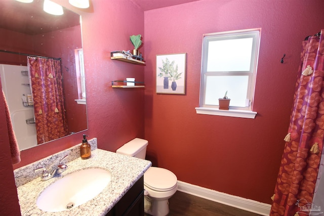 bathroom with hardwood / wood-style floors, vanity, and toilet