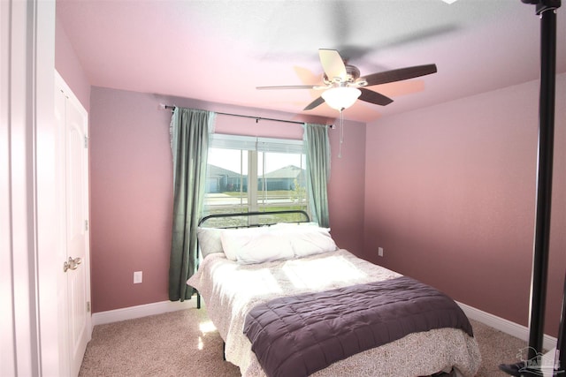 bedroom with ceiling fan and light colored carpet