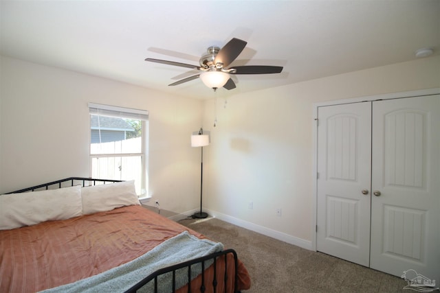 bedroom with carpet flooring, ceiling fan, and a closet