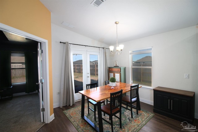 dining room featuring a chandelier, plenty of natural light, and lofted ceiling