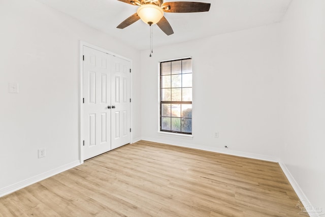 unfurnished bedroom with a closet, light hardwood / wood-style flooring, and ceiling fan