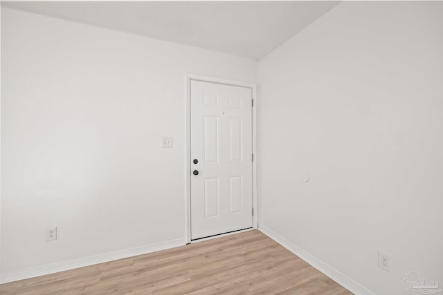 empty room with light hardwood / wood-style flooring