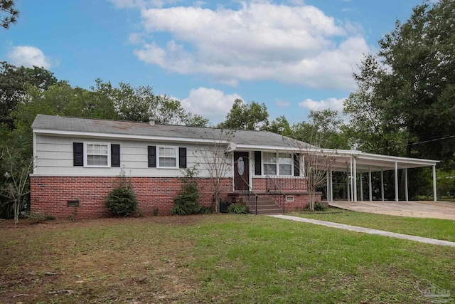 view of front of property with a carport and a front lawn