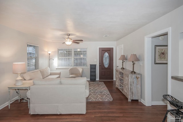 living room with ceiling fan and dark wood-type flooring