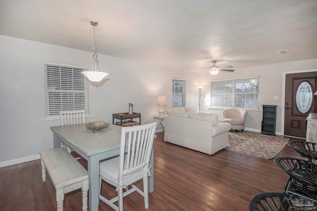 dining area featuring ceiling fan and dark wood-type flooring