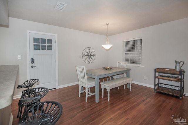 dining space featuring dark wood-type flooring