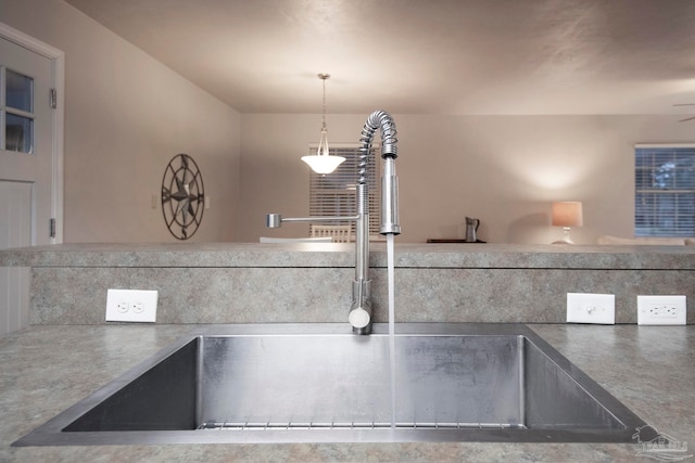 room details featuring pendant lighting, ceiling fan, and sink