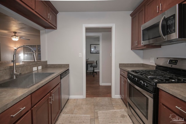 kitchen with ceiling fan, light tile patterned floors, sink, and appliances with stainless steel finishes