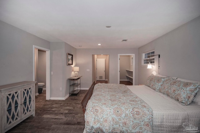 bedroom with dark hardwood / wood-style floors and connected bathroom