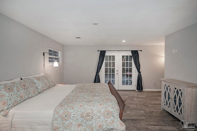 bedroom featuring access to exterior, dark hardwood / wood-style flooring, and french doors