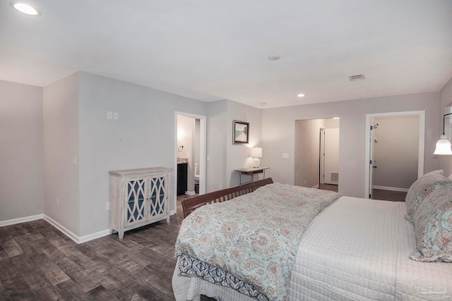 bedroom with ensuite bathroom and dark wood-type flooring