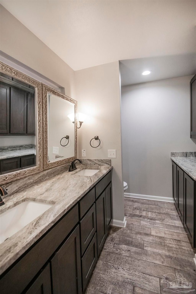 bathroom featuring hardwood / wood-style floors, vanity, and toilet