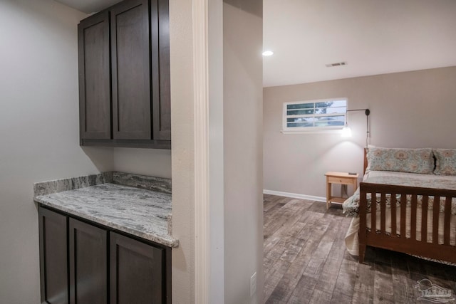 bedroom with dark hardwood / wood-style flooring