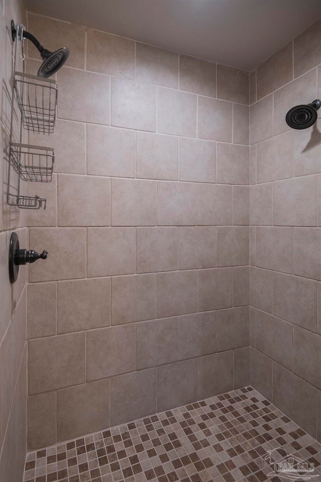 bathroom with a tile shower