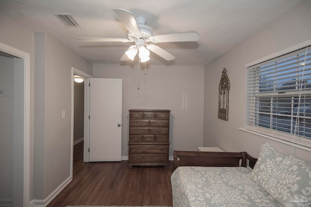 bedroom with ceiling fan and dark wood-type flooring