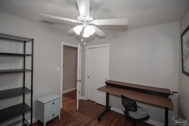 home office with dark hardwood / wood-style flooring and ceiling fan