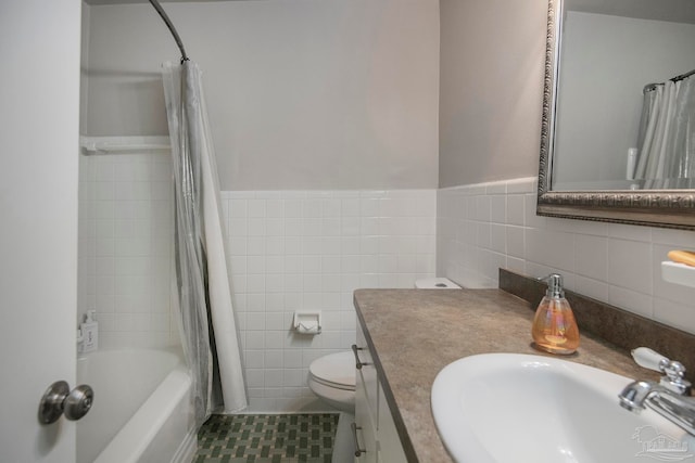 full bathroom featuring vanity, tile patterned floors, toilet, shower / bath combo with shower curtain, and tile walls