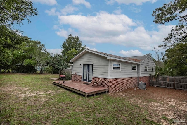 back of house featuring a yard and a wooden deck