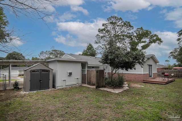 back of house featuring a yard, a storage shed, and a wooden deck