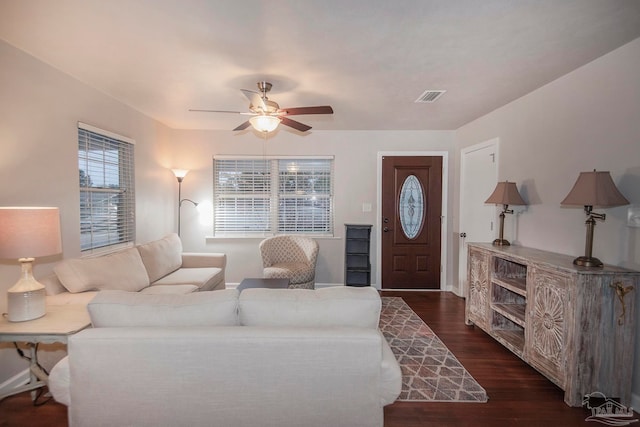 living room with ceiling fan and dark hardwood / wood-style flooring