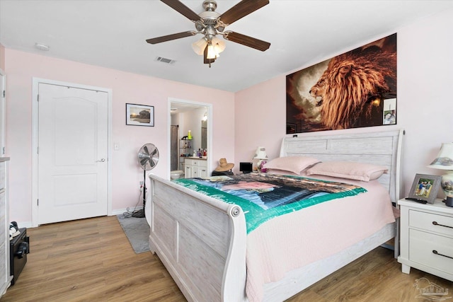 6819 Old W Ln, Milton, FL 32570 - bedroom featuring light wood-type flooring, a ceiling fan, ensuite bathroom, and baseboards