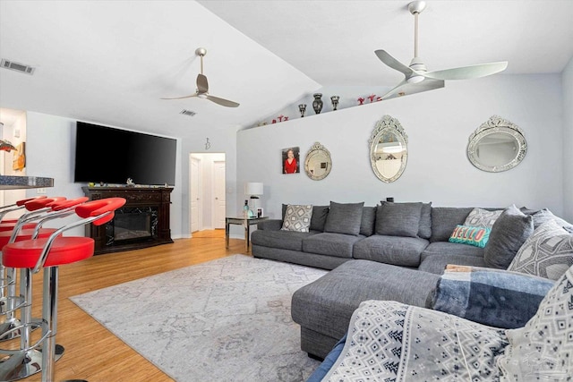 6819 Old W Ln, Milton, FL 32570 - living room with ceiling fan, wood finished floors, lofted ceiling, and a glass covered fireplace