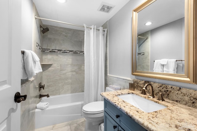 full bathroom featuring tile patterned flooring, vanity, toilet, and shower / tub combo