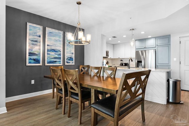 dining room featuring a chandelier, dark hardwood / wood-style flooring, and sink