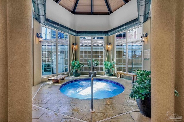 view of swimming pool featuring an indoor hot tub