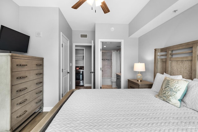 bedroom featuring light hardwood / wood-style floors, ensuite bathroom, and ceiling fan