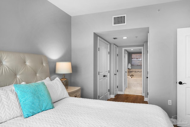 bedroom featuring wood-type flooring and ensuite bathroom