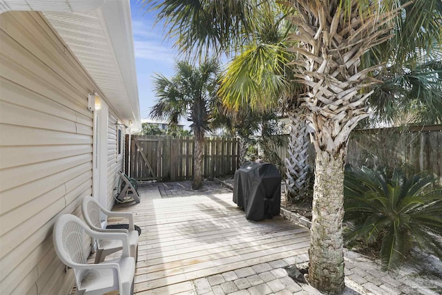 wooden terrace featuring a grill