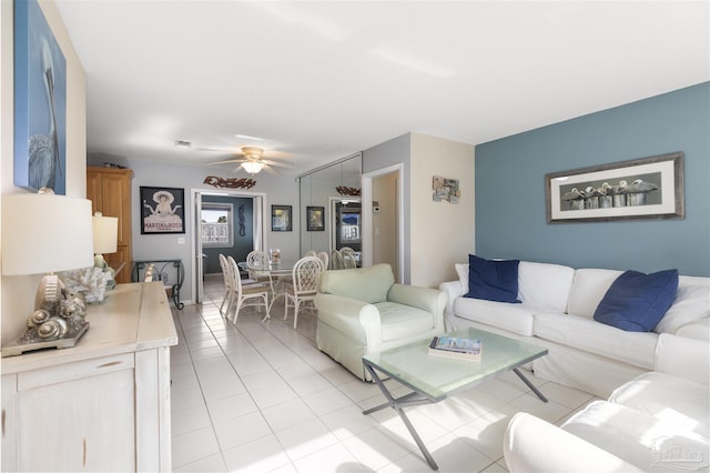 living room featuring ceiling fan and light tile patterned floors