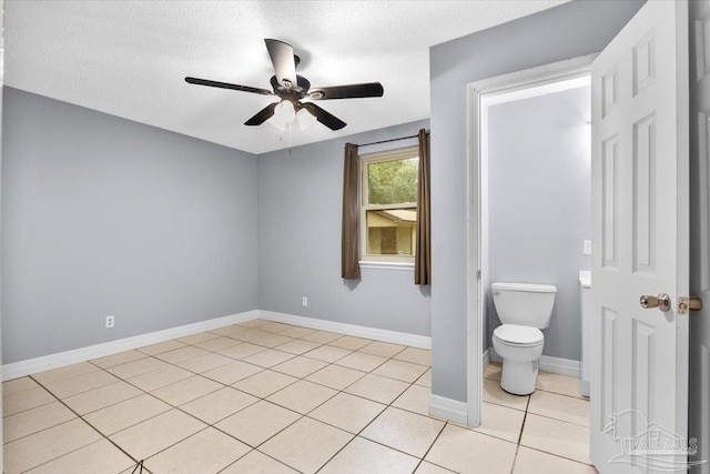 bathroom featuring tile patterned floors, ceiling fan, a textured ceiling, and toilet