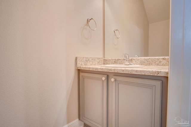 bathroom with vanity and vaulted ceiling