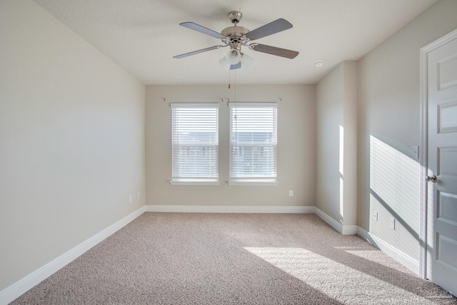 carpeted spare room featuring ceiling fan