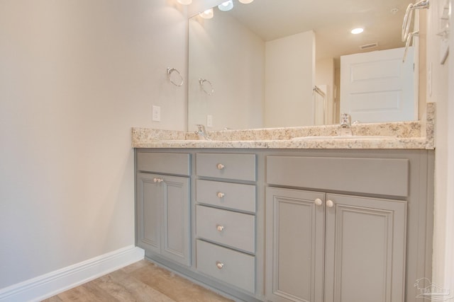 bathroom featuring vanity and hardwood / wood-style floors