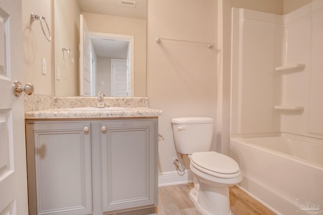 full bathroom featuring vanity, wood-type flooring, shower / tub combination, and toilet