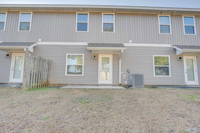 back of house with central AC unit