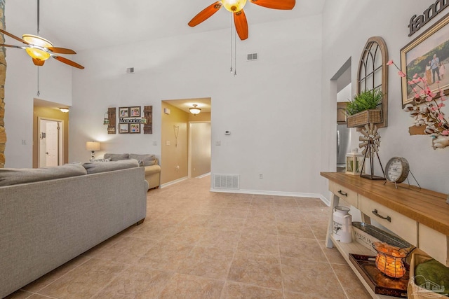 living room with high vaulted ceiling, visible vents, ceiling fan, and baseboards