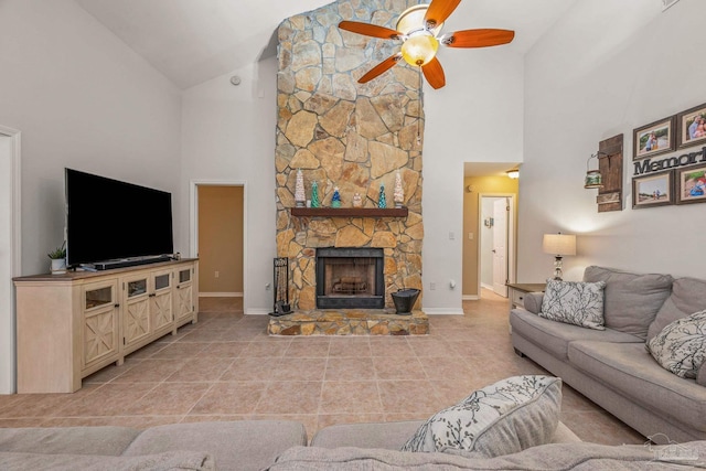 living area with light tile patterned floors, high vaulted ceiling, a fireplace, a ceiling fan, and baseboards