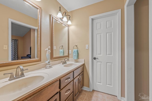 bathroom featuring double vanity, tile patterned flooring, and a sink