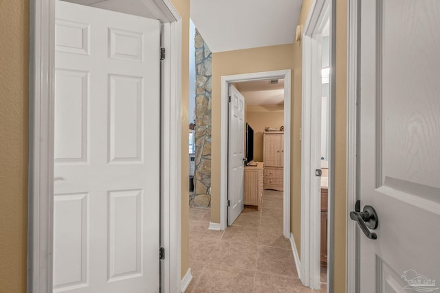 corridor featuring light tile patterned floors