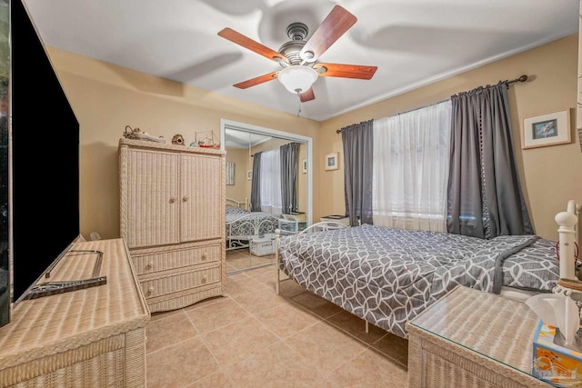 bedroom featuring a closet, ceiling fan, and light tile patterned floors