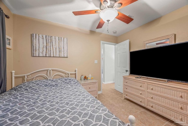 bedroom with a ceiling fan, visible vents, baseboards, and light tile patterned floors