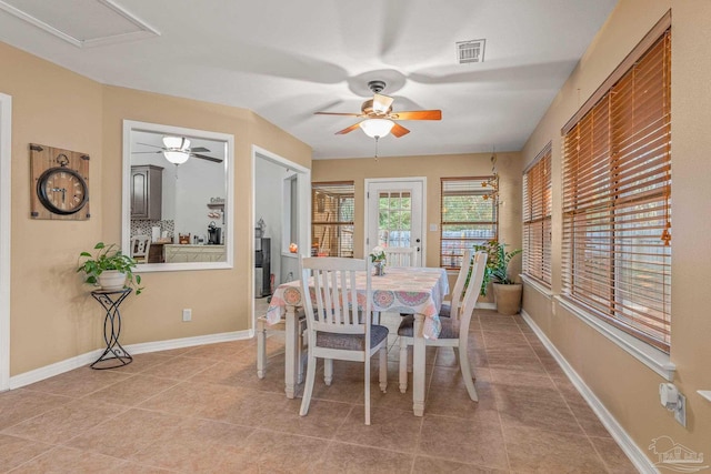 dining space with a ceiling fan, visible vents, baseboards, and light tile patterned floors