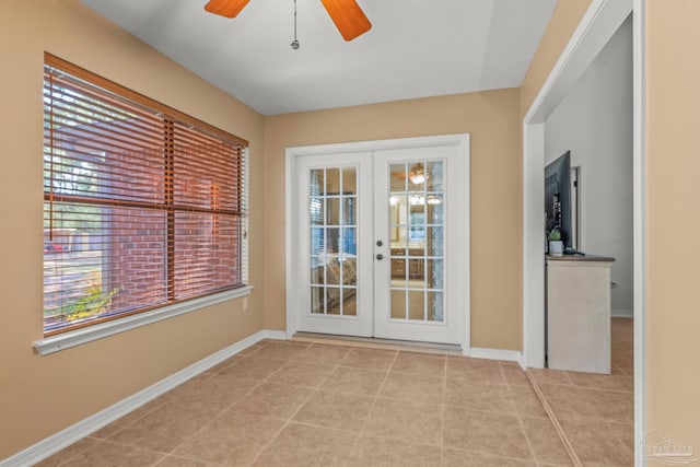 entryway featuring french doors, ceiling fan, baseboards, and tile patterned floors