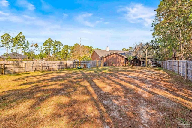 view of yard with a fenced backyard